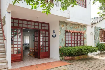 an entrance to a house with red doors at Hermosa Cabana con Piscina 3 Habitaciones MC21 in Coveñitas