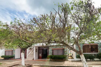 a house with two trees in front of it at Hermosa Cabana con Piscina 3 Habitaciones MC21 in Coveñitas