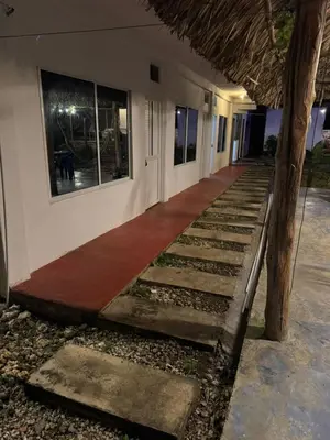 a hallway of a building with a red carpet at Hotel Paradise in Isla Fuerte