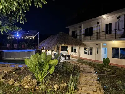 a building with a thatch roof at night at Hotel Paradise in Isla Fuerte