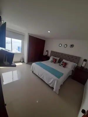 a bedroom with a large bed and a large window at APARTAMENTO CON VISTA AL MAR CARIBE PISO 19 - Espectacular in Cartagena de Indias