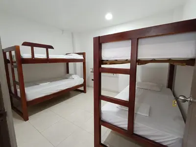 a room with three bunk beds in a room at Cabaña la Isla-Coveñas in Coveñas