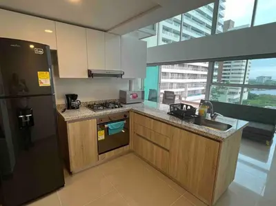 a kitchen with a stove and a sink and a refrigerator at APTO DUPLEX Bella vista Piscina y buena ubicación in Cartagena de Indias