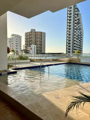 a swimming pool in a city with tall buildings at APTO DUPLEX Bella vista Piscina y buena ubicación in Cartagena de Indias