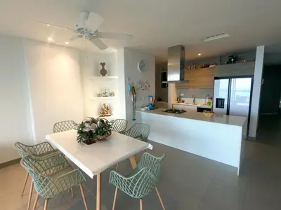 a kitchen and dining room with a table and chairs at hermoso apartamento en pozos colorados con playa privada y doble vista al mar in Santa Marta