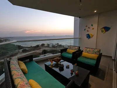 a living room with a view of the ocean at hermoso apartamento en pozos colorados con playa privada y doble vista al mar in Santa Marta