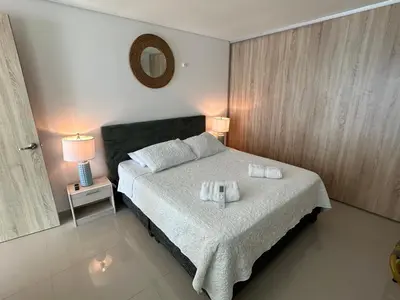 a bedroom with a bed with two towels on it at New Apartments with great Sunsets near historic center and beach in Cartagena de Indias