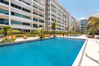 a swimming pool in front of a building at Morros 3 Apartamentos de Lujo in Cartagena de Indias