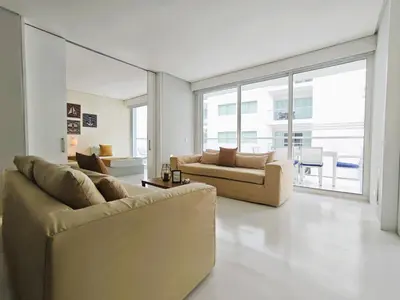 a living room with two couches and a large window at Morros 3 Apartamentos de Lujo in Cartagena de Indias