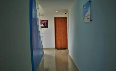 a hallway with a door and a tile floor and a hallway sidx sidx at Hotel La Yarolina SAS in Cartagena de Indias