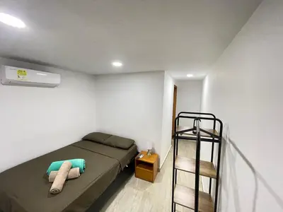 a bedroom with a bunk bed and a ladder at Hotel La Yarolina SAS in Cartagena de Indias