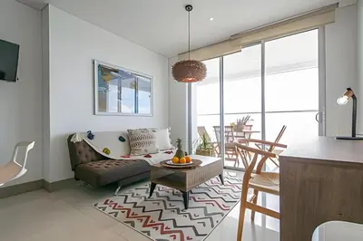 a living room with a couch and a table at Laurdhomes Palmetto Beach Sea View, for working in Cartagena de Indias