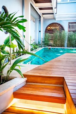 a wooden path leading to a pool in a house at Hotel Casona del Porvenir in Cartagena de Indias
