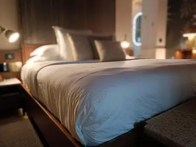 a bed with white sheets and pillows in a room at Hotel Casona del Porvenir in Cartagena de Indias