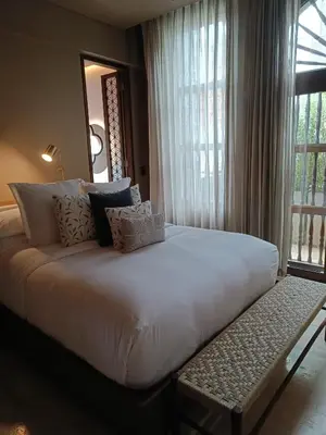 a large white bed in a room with a window at Hotel Casona del Porvenir in Cartagena de Indias