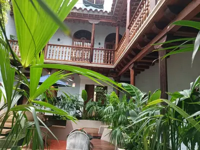 a courtyard with plants in front of a building at Hotel Casona del Porvenir in Cartagena de Indias