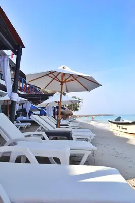 a group of chairs and an umbrella on a beach at Gafitas in Playa Blanca
