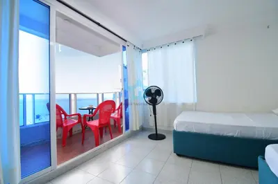 a bedroom with a bed and a balcony with a table and chairs at apartamento con vista piso 20 in Cartagena de Indias