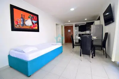 a bedroom with a bed and a table and chairs at apartamento con vista piso 20 in Cartagena de Indias
