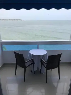 a table and two chairs on a balcony with the ocean at Hermoso apartamento con vista al mar in Cartagena de Indias