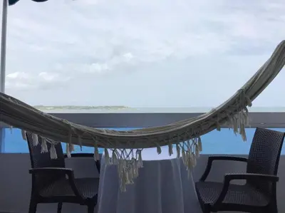 a hammock in a room with a view of the ocean at Hermoso apartamento con vista al mar in Cartagena de Indias