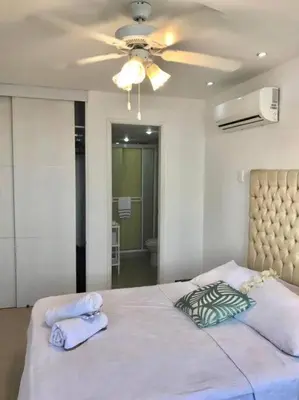 a bedroom with a large bed with a ceiling fan at Hermoso apartamento con vista al mar in Cartagena de Indias