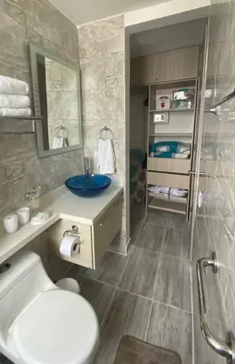 a bathroom with a toilet and a sink and a mirror at apartamento en bocagrande in Cartagena de Indias