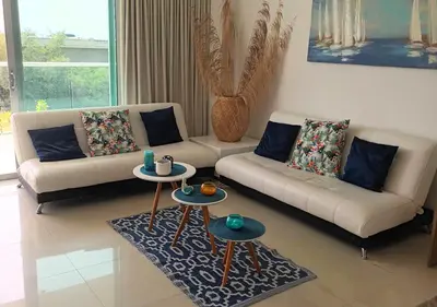 a living room with two couches and two tables at Espectacular apartamento Morros Epic Cartagena, Acceso directo a la playa in Cartagena de Indias
