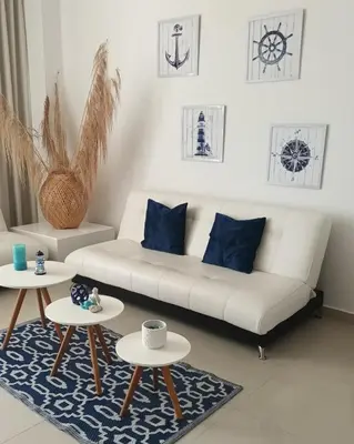 a living room with a white couch and two tables at Espectacular apartamento Morros Epic Cartagena, Acceso directo a la playa in Cartagena de Indias