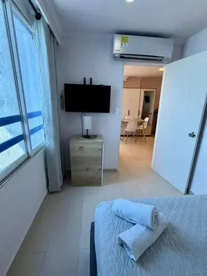a bedroom with a bed and a flat screen tv at CARTAGENA LA FANTASTICA in Cartagena de Indias