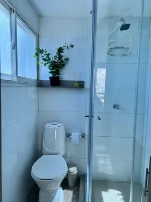 a bathroom with a toilet and a glass shower at CARTAGENA LA FANTASTICA in Cartagena de Indias