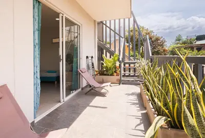 a balcony of a house with a chair and plants at Casa Bacoba in Santa Marta