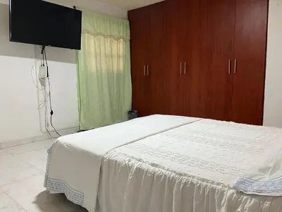 a bedroom with a bed with a tv on the wall at Casa Encanto Cartagena Colombia in Cartagena de Indias