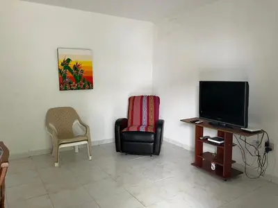 a living room with a tv and a chair at Casa Encanto Cartagena Colombia in Cartagena de Indias