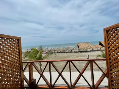a view of the beach from the balcony of a resort at Cabaña Yalis SAS in Cartagena de Indias