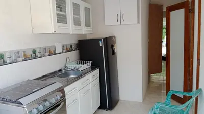 a kitchen with a black refrigerator and a sink at Apartamento Excelente Ubicación Cartagena - Nuevo Bosque - Seguridad in Cartagena de Indias