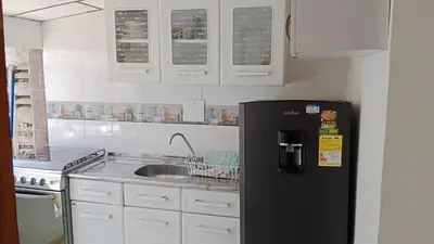 a kitchen with a black refrigerator and a sink at Apartamento Excelente Ubicación Cartagena - Nuevo Bosque - Seguridad in Cartagena de Indias