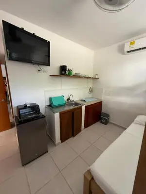 a small kitchen with a sink and a tv on the wall at Apartaestudio Playa Linda 101 in Coveñas