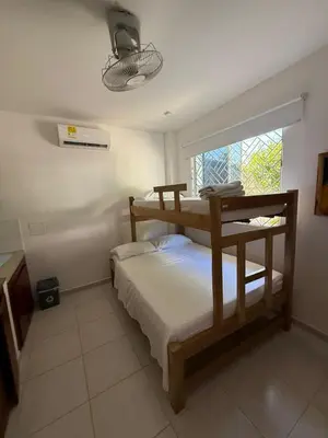 a bedroom with two bunk beds and a window at Apartaestudio Playa Linda 101 in Coveñas