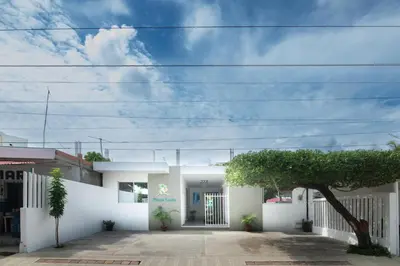 a white house with a tree in front of it at Apartaestudio Playa Linda 101 in Coveñas