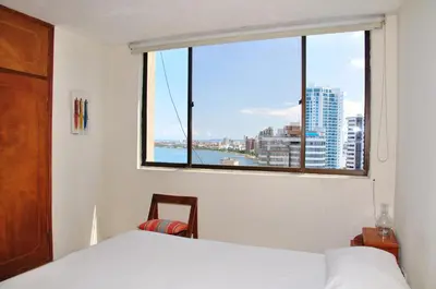 a bedroom with a window with a view of a city at II-Nice and cozy 2 bedroom Apt BOCAGRANDE in Cartagena de Indias
