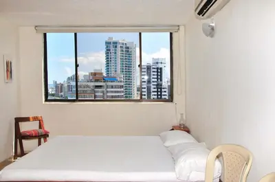 a bedroom with a white bed and a window at II-Nice and cozy 2 bedroom Apt BOCAGRANDE in Cartagena de Indias