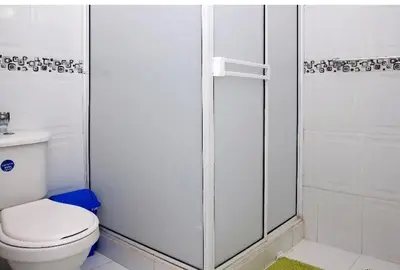 a white bathroom with a toilet and a shower at II-Nice and cozy 2 bedroom Apt BOCAGRANDE in Cartagena de Indias