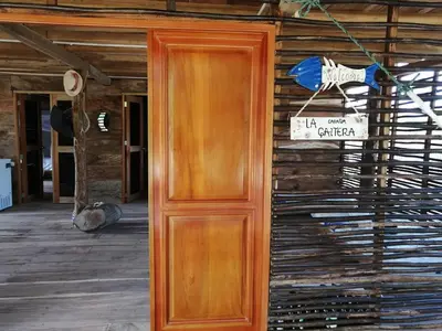 a wooden door on the side of a house at LA GAITERA Cabaña in Moñitos