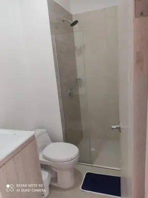 a bathroom with a shower and a toilet and a sink at Edificio Sierra Beach Resort Pozos Colorados vista y salida al mar in Santa Marta