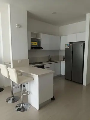 an empty kitchen with a counter and a refrigerator at Edificio Sierra Beach Resort Pozos Colorados vista y salida al mar in Santa Marta