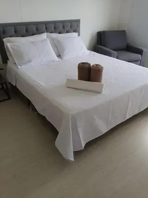 a bed with two baskets on top of it at Edificio Sierra Beach Resort Pozos Colorados vista y salida al mar in Santa Marta