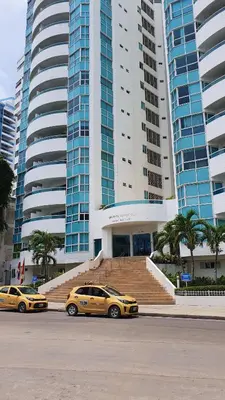 two yellow taxis parked in front of a large building at Apartamento en el Sector El Laguito in Cartagena de Indias
