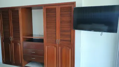 a wooden cabinet with a flat screen tv at Apartamento en el Sector El Laguito in Cartagena de Indias