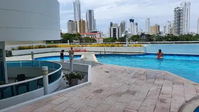 a large swimming pool with a city in the background at Apartamento en el Sector El Laguito in Cartagena de Indias